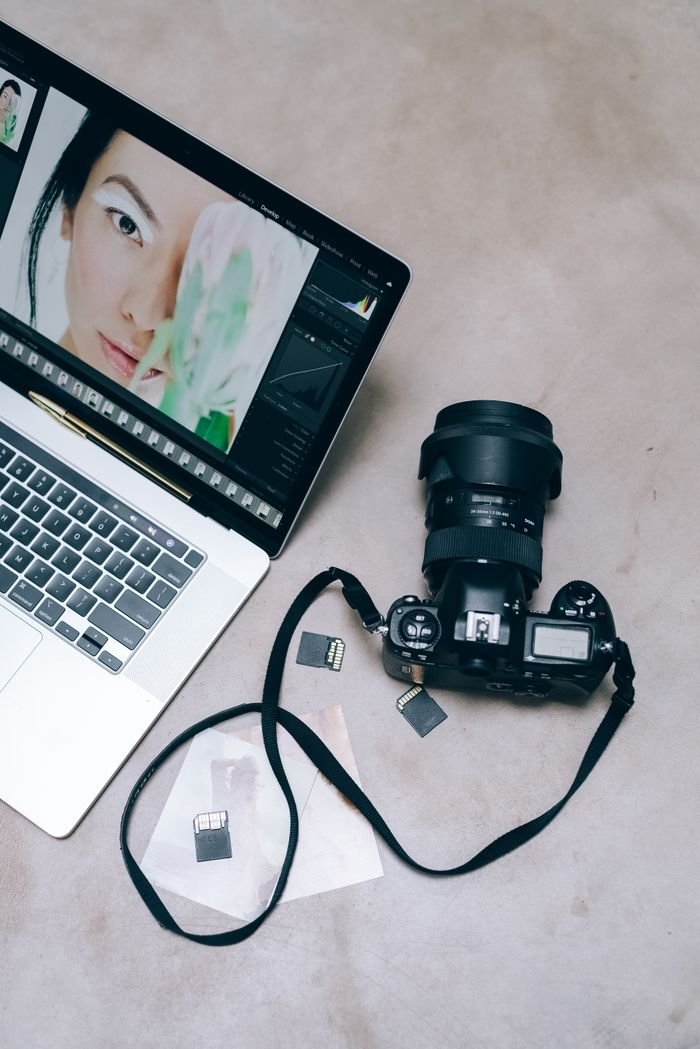 Mastering the First Impression: Your intriguing post title goes here Flat lay of a DSLR camera and laptop for photo editing.